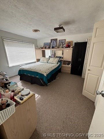 carpeted bedroom with a textured ceiling