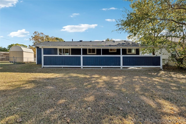 back of property featuring a lawn