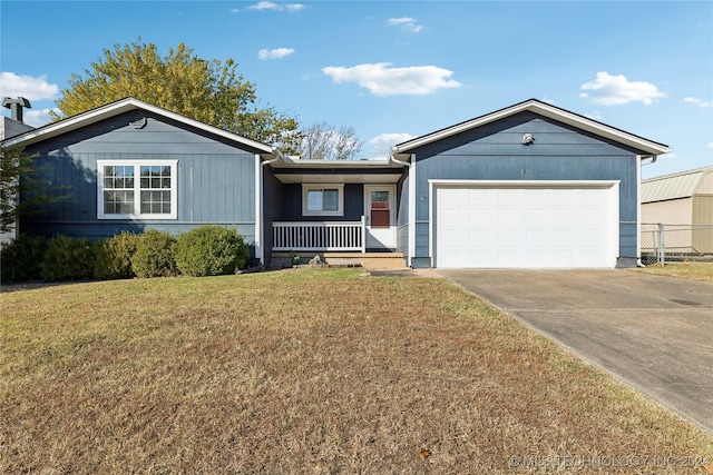 single story home featuring covered porch, a garage, and a front lawn