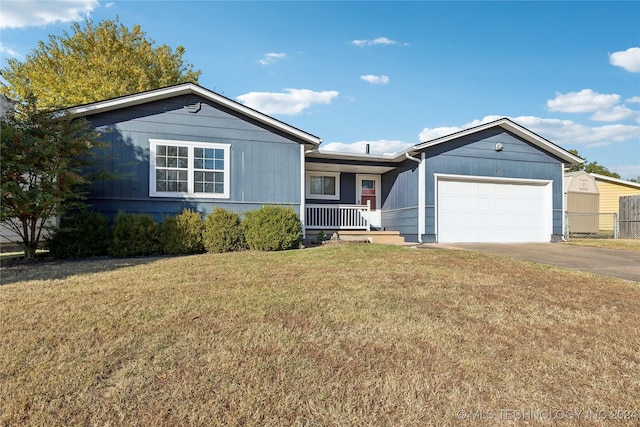 ranch-style home with a porch, a front yard, and a garage