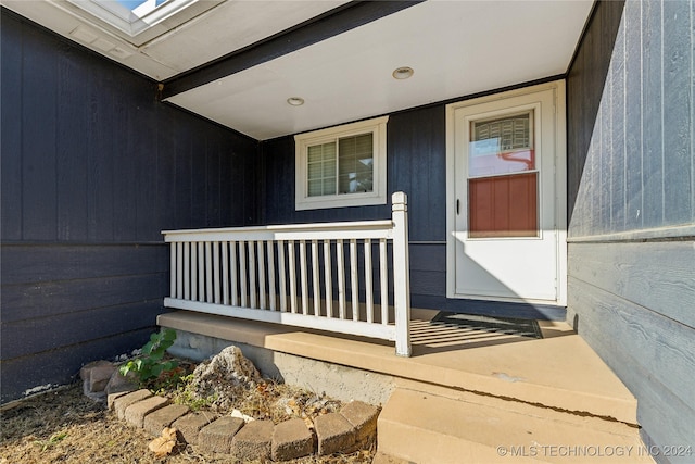 view of exterior entry with a porch