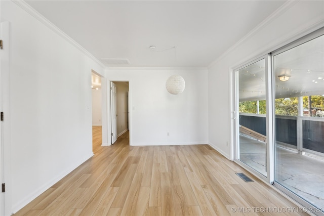 unfurnished room with light wood-type flooring and ornamental molding