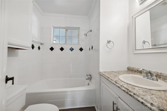 full bathroom featuring crown molding, vanity, tiled shower / bath combo, and toilet