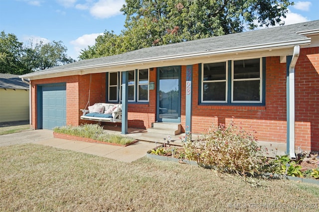 ranch-style house featuring a garage and a front lawn