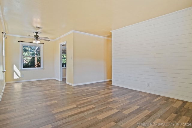 unfurnished room with hardwood / wood-style flooring, ceiling fan, and ornamental molding