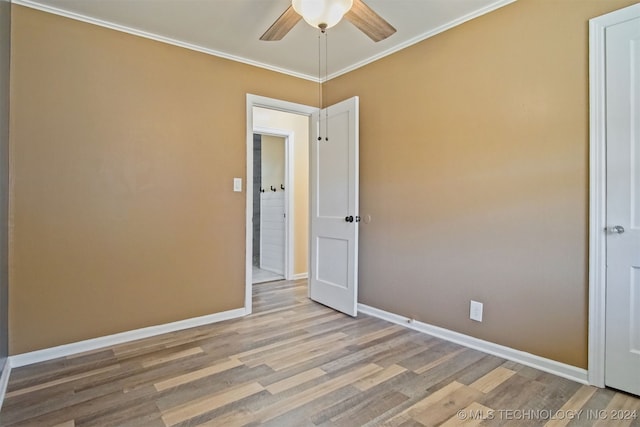 empty room featuring crown molding, ceiling fan, and light hardwood / wood-style floors