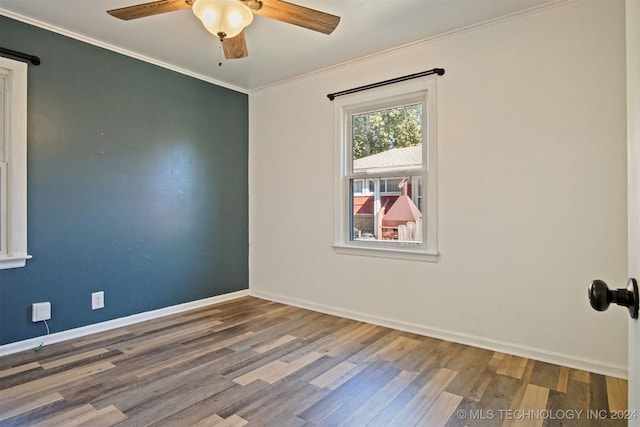 spare room featuring hardwood / wood-style floors, ceiling fan, and crown molding