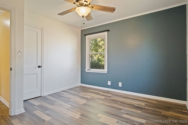 empty room with crown molding, ceiling fan, and light wood-type flooring