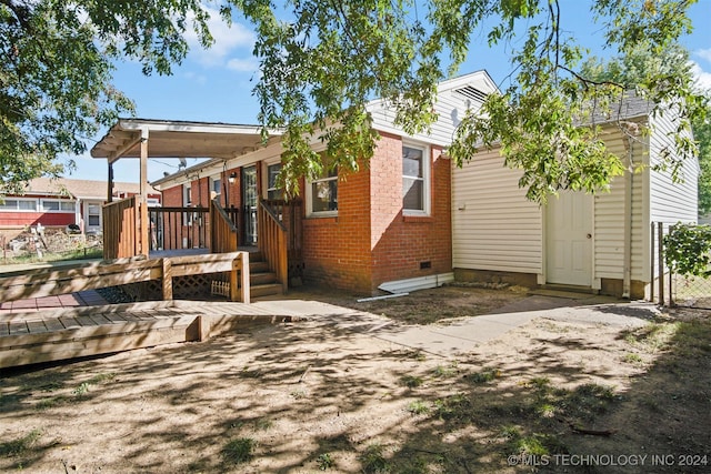 rear view of house with a wooden deck