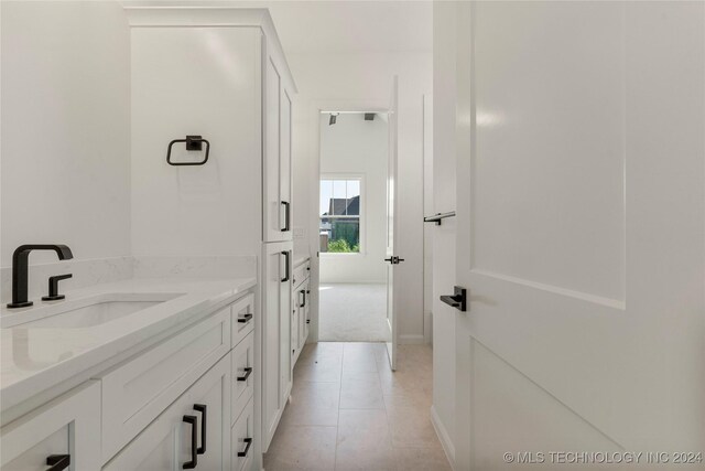 bathroom with tile patterned floors and vanity