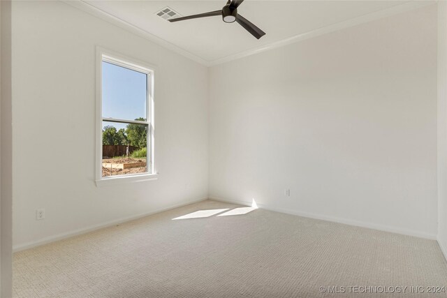 carpeted spare room featuring ceiling fan and ornamental molding