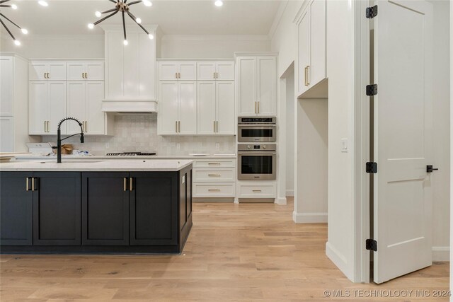 kitchen featuring an inviting chandelier, white cabinets, light hardwood / wood-style flooring, ornamental molding, and double oven