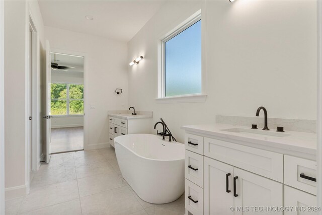 bathroom featuring tile patterned floors, ceiling fan, a tub to relax in, and vanity