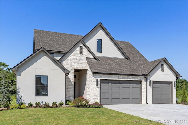 view of front of home featuring a garage and a front yard