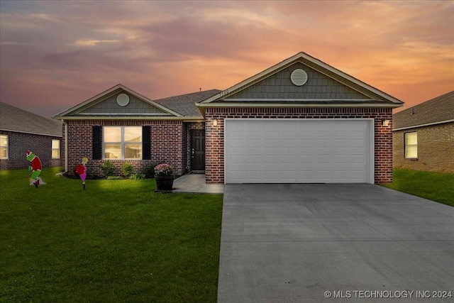 view of front of home featuring a garage and a yard