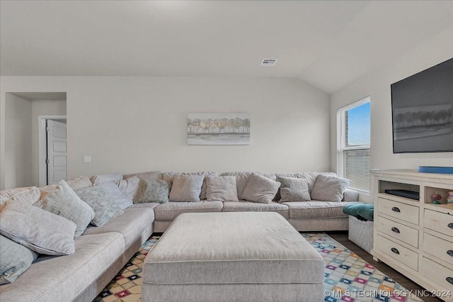 living room featuring vaulted ceiling and hardwood / wood-style floors