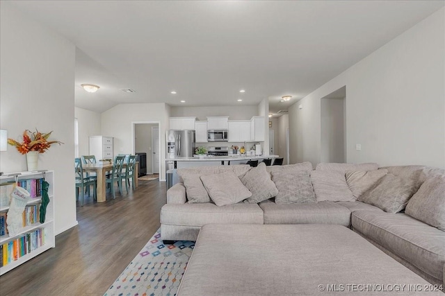 living room featuring dark hardwood / wood-style flooring and lofted ceiling