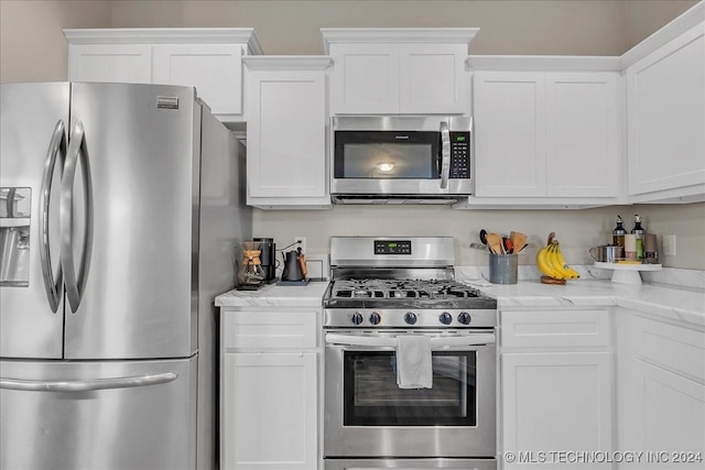 kitchen featuring stainless steel appliances and white cabinets