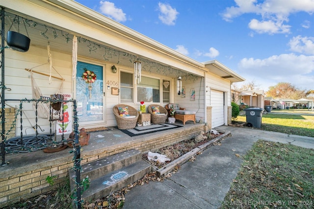 doorway to property featuring a porch and a garage