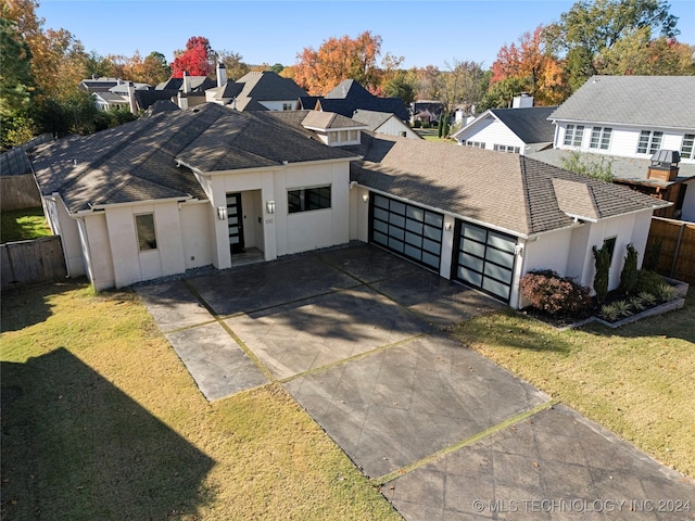 view of front facade featuring a front lawn and a garage