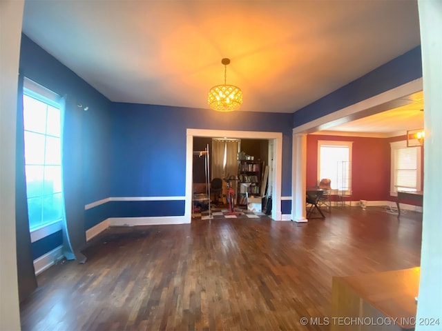 interior space with dark hardwood / wood-style floors and an inviting chandelier