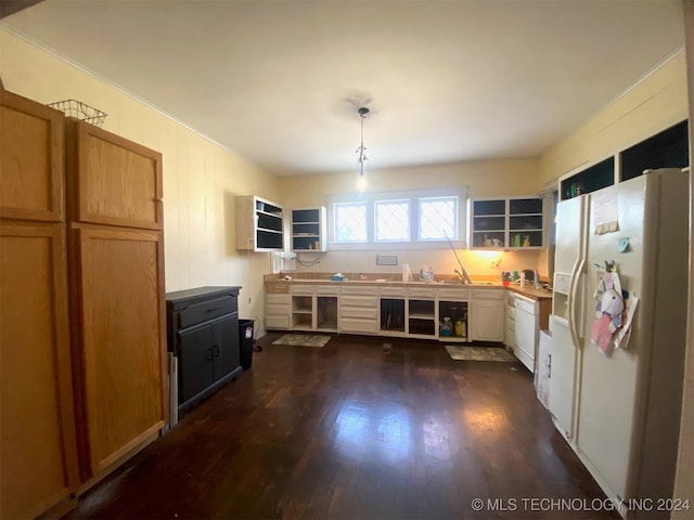 kitchen with white cabinetry, dark hardwood / wood-style flooring, hanging light fixtures, and white appliances