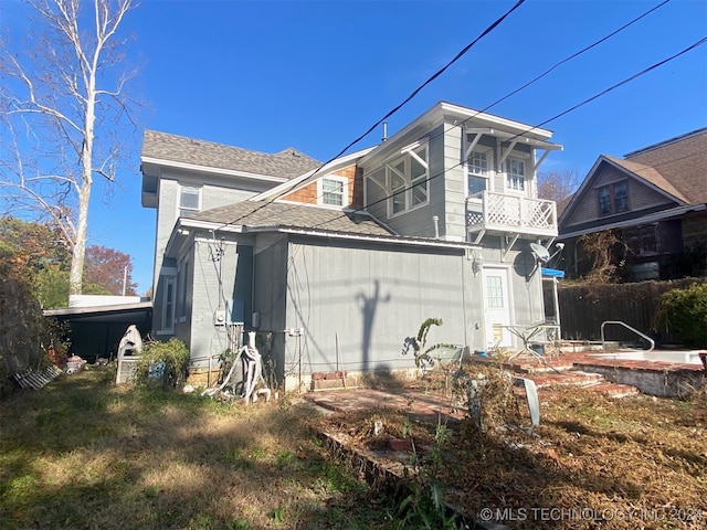 back of property featuring a balcony