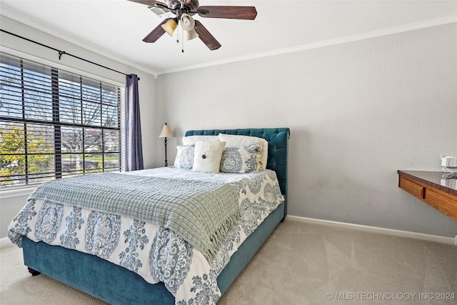 bedroom with ceiling fan, carpet floors, and ornamental molding