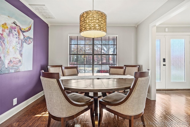 dining room featuring dark hardwood / wood-style floors and ornamental molding