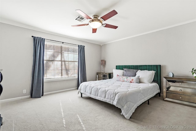 carpeted bedroom with ceiling fan and ornamental molding