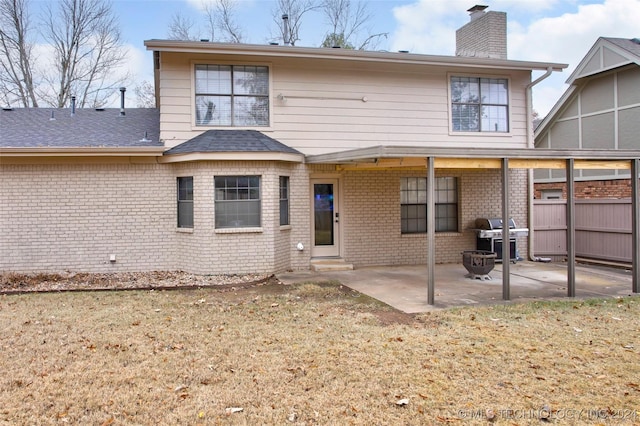 back of property featuring a yard and a patio