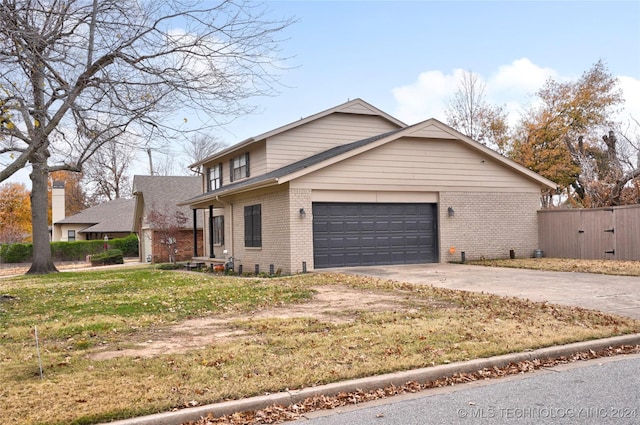 view of front of house featuring a garage and a front lawn