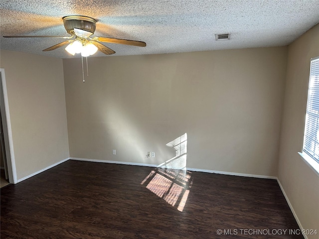 unfurnished room with a textured ceiling, ceiling fan, and dark hardwood / wood-style floors