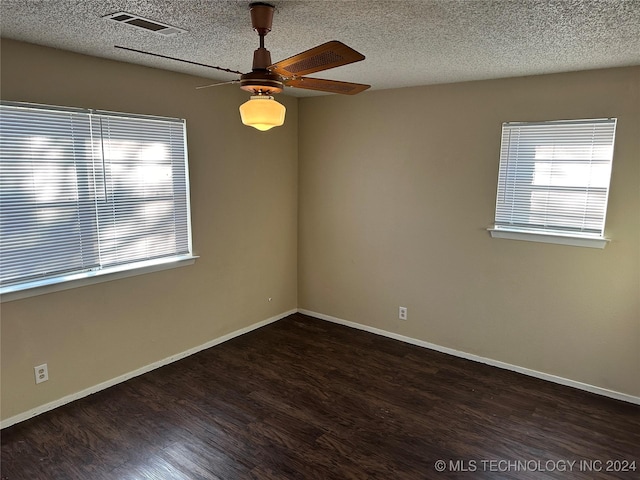 unfurnished room with a textured ceiling, ceiling fan, and dark hardwood / wood-style floors