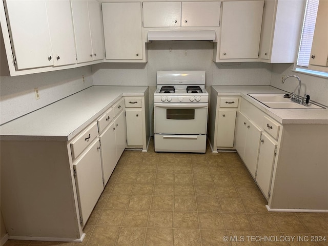 kitchen featuring ventilation hood, white gas stove, white cabinetry, and sink