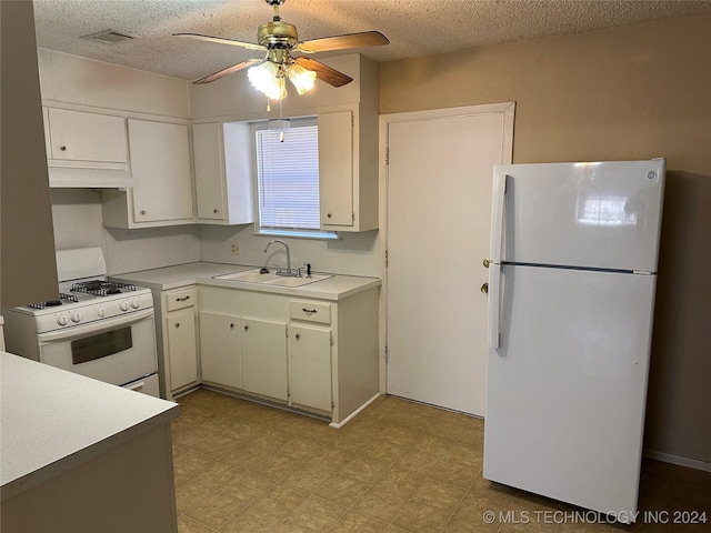 kitchen featuring a textured ceiling, sink, white cabinets, and white appliances