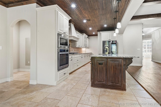 kitchen with range hood, a kitchen island with sink, white cabinets, wood ceiling, and appliances with stainless steel finishes