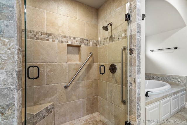 bathroom featuring separate shower and tub