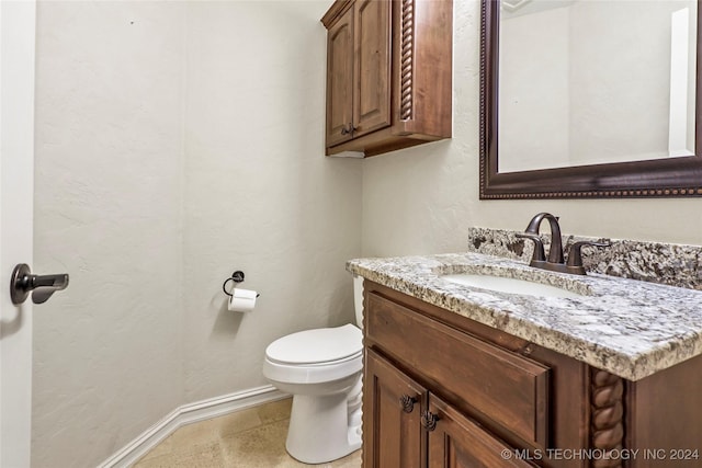 bathroom featuring tile patterned floors, vanity, and toilet