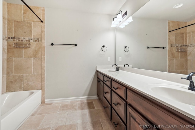 bathroom featuring vanity and tiled shower / bath