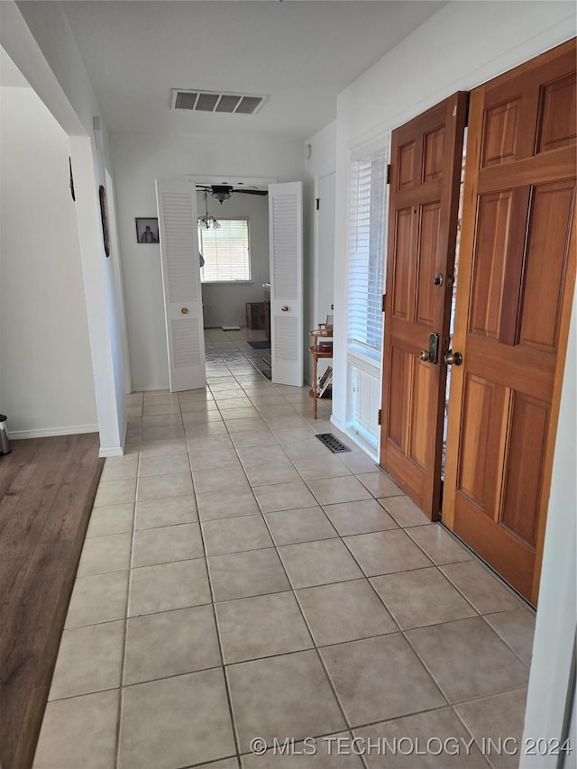 hallway with light hardwood / wood-style floors