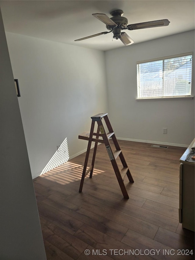 interior space featuring ceiling fan and dark wood-type flooring