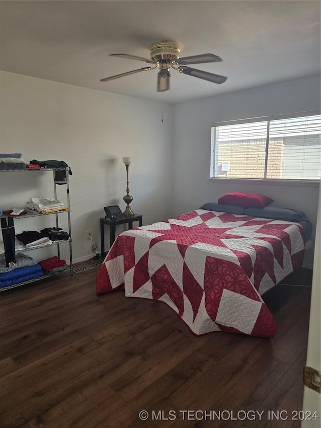 bedroom with ceiling fan and dark wood-type flooring