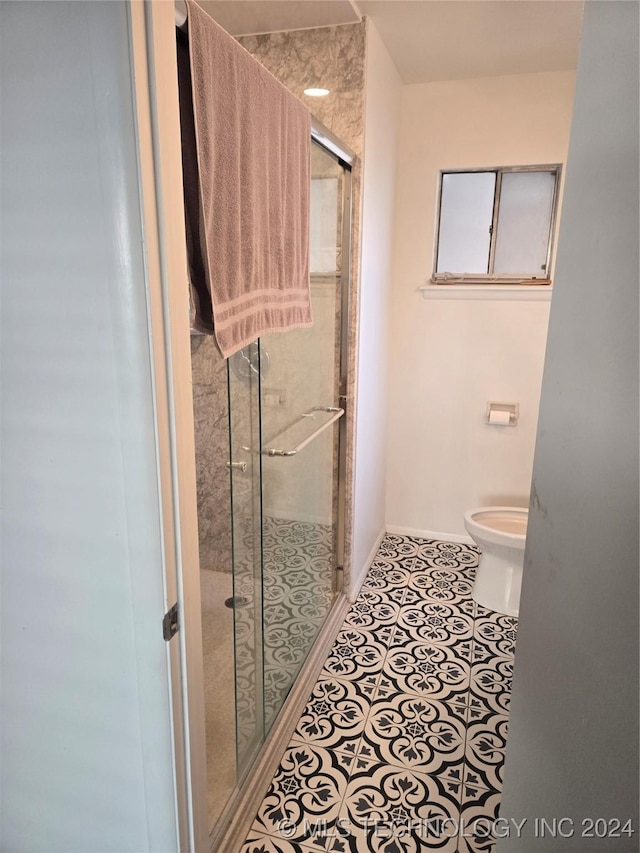 bathroom with an enclosed shower, tile patterned flooring, and toilet