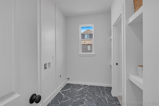 clothes washing area featuring laundry area, marble finish floor, hookup for a washing machine, and baseboards