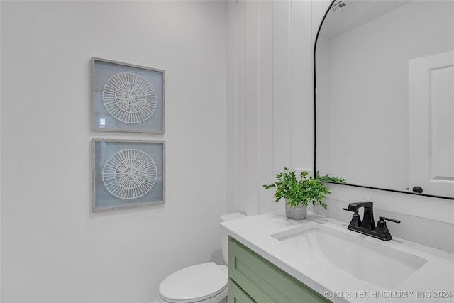 bathroom featuring visible vents, toilet, and vanity