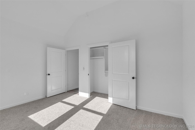 unfurnished bedroom with vaulted ceiling, baseboards, a closet, and carpet floors