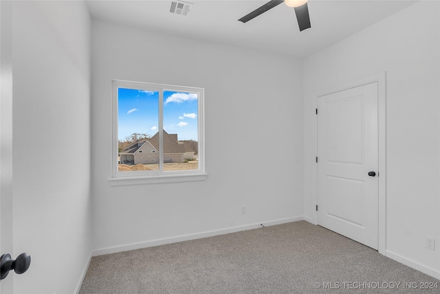 empty room with light carpet and ceiling fan