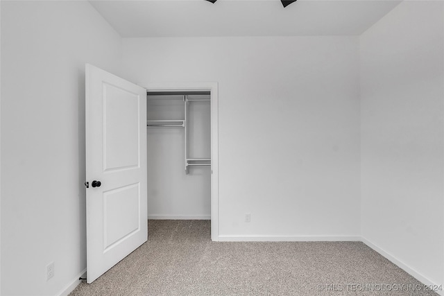 unfurnished bedroom with carpet flooring and a closet