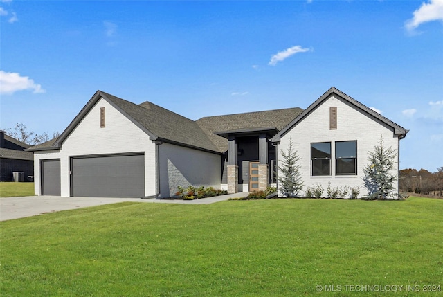 view of front of property with brick siding, an attached garage, concrete driveway, and a front yard